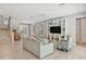 Open-concept living room with neutral colors, built-in shelving, and access to the staircase and other rooms at 149 Mckinley Dr, Sarasota, FL 34236