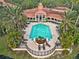 Aerial view of a community pool surrounded by palm trees and lounge chairs at 4102 Central Sarasota Pkwy # 926, Sarasota, FL 34238