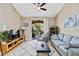 Bright living room with neutral tones, ceiling fan, sliding glass doors to balcony, and comfortable seating arrangement at 4102 Central Sarasota Pkwy # 926, Sarasota, FL 34238