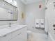 Modern bathroom with white vanity, bathtub, and frameless mirror at 1542 4Th St # 212, Sarasota, FL 34236