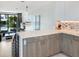 Open concept kitchen with island and living room view at 1542 4Th St # 212, Sarasota, FL 34236