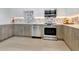 Modern kitchen with stainless steel appliances and light wood cabinets at 1542 4Th St # 212, Sarasota, FL 34236