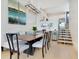 Elegant dining room featuring a wood table, chandelier, and built-in bar area at 1542 4Th St # 212, Sarasota, FL 34236