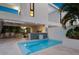 Outdoor oasis with a refreshing pool, patio seating, and built-in grilling station at 1542 4Th St # 212, Sarasota, FL 34236