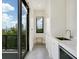 Small kitchenette with sink, mini-fridge, and access to balcony at 1542 4Th St # 212, Sarasota, FL 34236