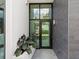 Modern building exterior with glass doors and plants at 1542 4Th St # 212, Sarasota, FL 34236