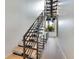 Modern staircase with sleek metal railing and light wood steps at 1542 4Th St # 212, Sarasota, FL 34236