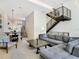 Open living room with modern furniture and stairs at 1542 4Th St # 212, Sarasota, FL 34236