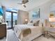 Spacious bedroom with a king-size bed, balcony access, and stylish decor at 1542 4Th St # 212, Sarasota, FL 34236