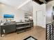 Open living area with sectional sofa, large TV, and access to outdoor patio at 1542 4Th St # 212, Sarasota, FL 34236
