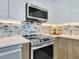 Stainless steel appliances and modern backsplash in kitchen at 1542 4Th St # 212, Sarasota, FL 34236
