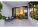 Private patio with lounge chairs and view into the living area at 1542 4Th St # 212, Sarasota, FL 34236