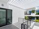 Ground floor patio with pergola, providing shade and outdoor space at 1542 4Th St # 212, Sarasota, FL 34236
