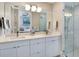 Modern bathroom with double vanity, large mirror, and glass shower at 1542 4Th St # 212, Sarasota, FL 34236