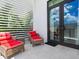 Private balcony with comfortable seating and white privacy screen at 1542 4Th St # 212, Sarasota, FL 34236