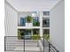 Private courtyard with lush tropical plants and a view of the community pool at 1542 4Th St # 212, Sarasota, FL 34236