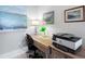 Home office features a large desk, printer, and comfortable chair at 1542 4Th St # 212, Sarasota, FL 34236