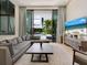 Bright living room with comfortable seating, large TV, and sliding glass doors leading to a view of the pool at 1542 4Th St # 212, Sarasota, FL 34236