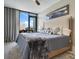 Main bedroom features a king-size bed and large window with city view at 1542 4Th St # 212, Sarasota, FL 34236