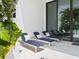 Relaxing patio with three lounge chairs, providing ample space for outdoor enjoyment at 1542 4Th St # 212, Sarasota, FL 34236