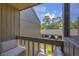 Private balcony overlooking lush landscaping and parking at 207 Woodland Dr # 207, Osprey, FL 34229