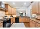 Well-equipped kitchen featuring wood cabinets, granite counters, and modern appliances at 207 Woodland Dr # 207, Osprey, FL 34229