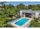 Community pool with patio furniture and canal views at 207 Woodland Dr # 207, Osprey, FL 34229