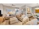Relaxing living room featuring neutral sofas, an ottoman, and a TV at 207 Woodland Dr # 207, Osprey, FL 34229