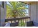 Private balcony with view of tropical foliage at 207 Woodland Dr # 207, Osprey, FL 34229