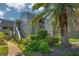 Condo building with lush landscaping and walkway at 207 Woodland Dr # 207, Osprey, FL 34229