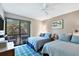 Bedroom with two twin beds and access to balcony at 207 Woodland Dr # 207, Osprey, FL 34229