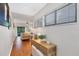 Light-filled hallway with wood floors, offering views to living room and other rooms at 207 Woodland Dr # 207, Osprey, FL 34229