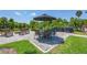 Relaxing outdoor patio with seating, umbrella, and grill at 207 Woodland Dr # 207, Osprey, FL 34229