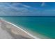 Stunning aerial view of a pristine beach with clear, turquoise water at 207 Woodland Dr # 207, Osprey, FL 34229