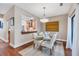 Elegant dining room with glass table, neutral decor, and kitchen views at 207 Woodland Dr # 207, Osprey, FL 34229