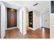 Bright entryway with hardwood floors, built-in shelving, and access to other rooms at 207 Woodland Dr # 207, Osprey, FL 34229