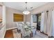Bright dining area with glass-top table and access to balcony at 207 Woodland Dr # 207, Osprey, FL 34229