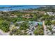 Aerial view showcasing community, tennis courts, and waterway at 207 Woodland Dr # 207, Osprey, FL 34229