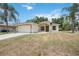 Newly built one-story house with a beige exterior and a grassy lawn at 3658 Spinner Ave, North Port, FL 34286