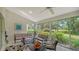 Peaceful sunroom overlooking the golf course, featuring comfortable seating and a relaxing atmosphere at 4440 Calle Serena, Sarasota, FL 34238