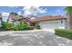 Villa with a tile roof, two-car garage, and well-maintained landscaping at 4440 Calle Serena, Sarasota, FL 34238