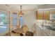 Cozy breakfast nook with wood table and access to patio at 4440 Calle Serena, Sarasota, FL 34238