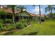 Row of villas with lush landscaping and a green lawn at 4440 Calle Serena, Sarasota, FL 34238