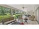 Bright sunroom with golf course views, comfortable seating, and plenty of natural light at 4440 Calle Serena, Sarasota, FL 34238