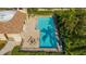 Community pool and adjacent building with tiled patio at 4440 Calle Serena, Sarasota, FL 34238