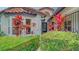 Front entrance with lush tropical plants and decorative gate at 4440 Calle Serena, Sarasota, FL 34238