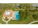 Community pool with adjacent building and lounge chairs at 4440 Calle Serena, Sarasota, FL 34238