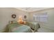 Bright guest bedroom with two twin beds and large window at 4440 Calle Serena, Sarasota, FL 34238