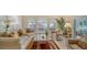 Spacious living room with neutral colored couches, a large window, and a marble coffee table at 4440 Calle Serena, Sarasota, FL 34238