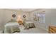 Guest bedroom with twin beds and ample natural light at 4440 Calle Serena, Sarasota, FL 34238